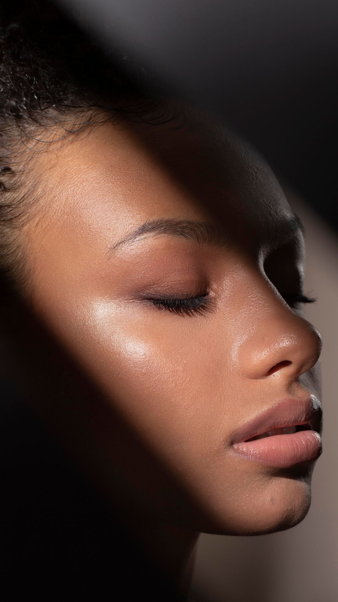 Dunkelhäutiges attraktives Gesicht glänz im Licht nach BB Glow